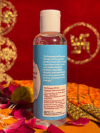 Side view of Pure Gangajal bottle with sacred red cloth background