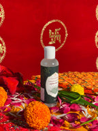 Bottle of Satya Sanatani Natural Kewra Water with puja flowers and Swastik backdrop