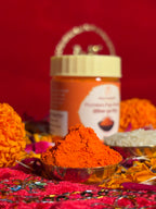 Devotional Sindoor container surrounded by rose and marigold flowers for rituals