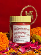 Roli jar displayed with marigold and rose petals for puja