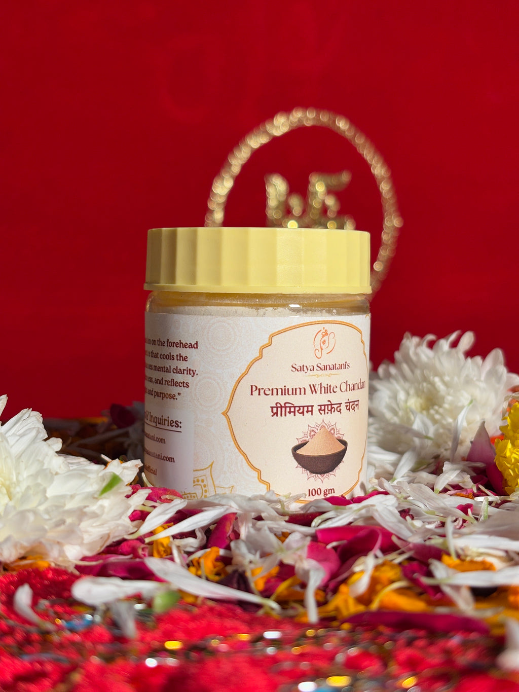 Premium White Chandan powder container with puja flowers and Swastik backdrop