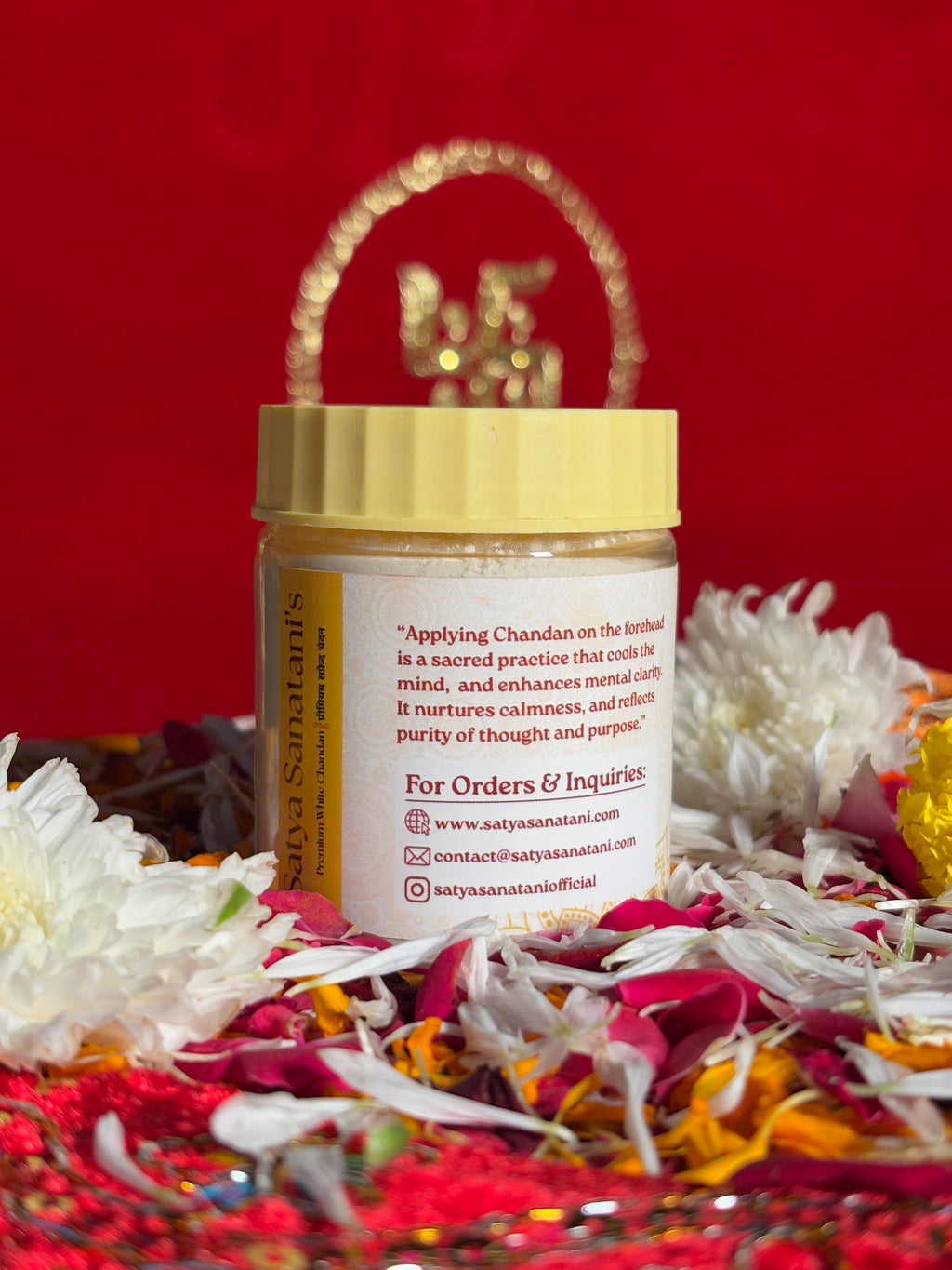 Open container of White Sandalwood powder displayed with marigold petals