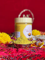 Yellow Chandan powder container surrounded by marigold and rose petals for rituals