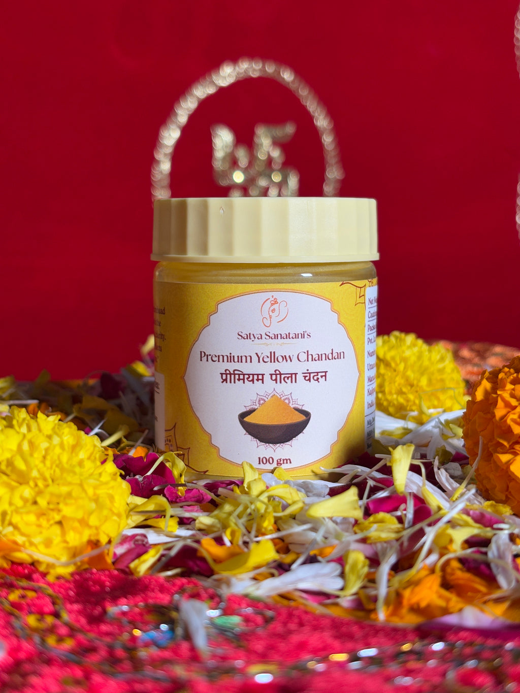 Premium devotional Yellow Chandan container front view with saffron background