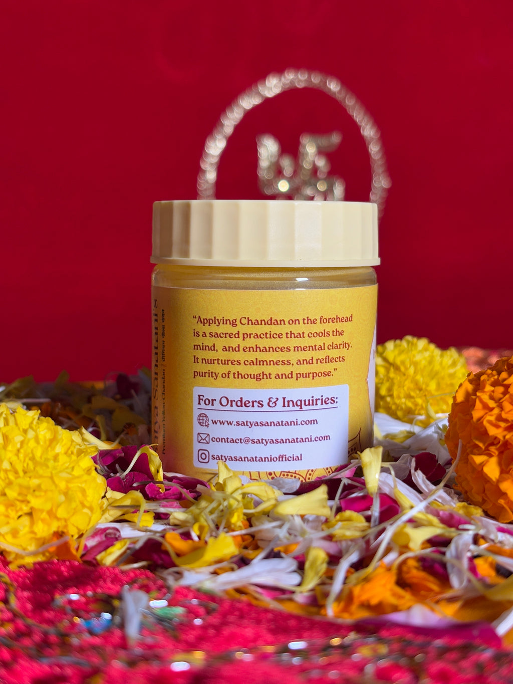 Side view of Yellow Chandan jar with red sacred altar cloth
