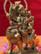 Decorative shot of Maa Durga brass murti with marigold and rose petals