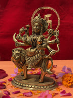 Side view of Mahishasura Mardini Durga brass murti with lion and divine weapons
